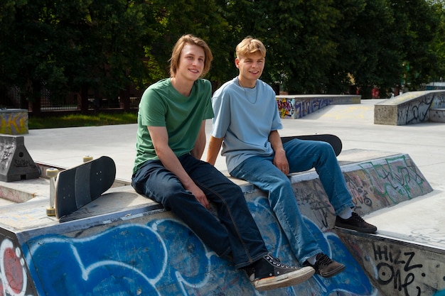 Full shot teens sitting outdoors