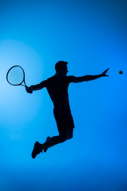 Full shot tennis player jumping