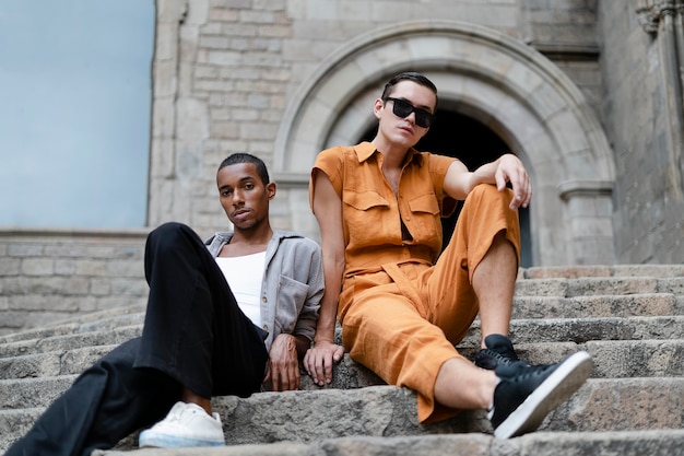 Full shot transgenders sitting on stairs