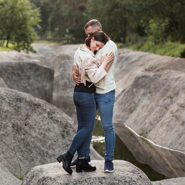 Full shot travel couple hugging