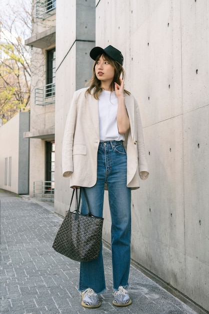 Full shot trendy woman with trucker hat