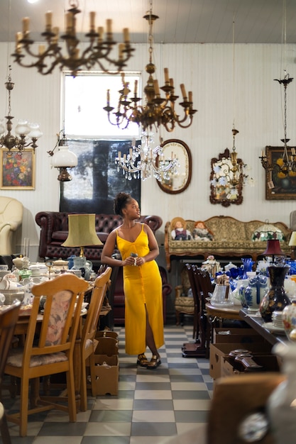 Free photo full shot woman at the antique store