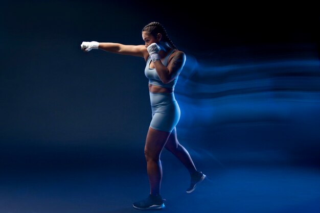 Full shot woman boxing