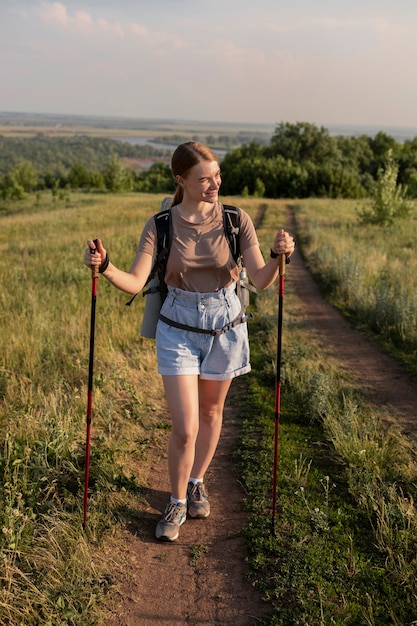 Full shot woman carrying backpack