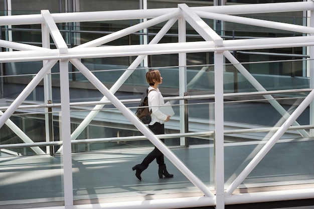 Free photo full shot woman carrying laptop