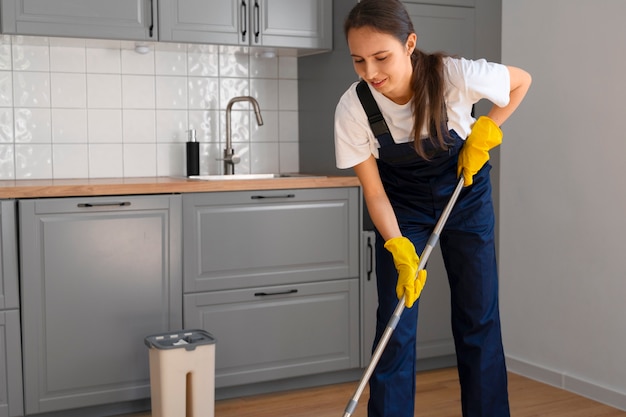 Free photo full shot woman cleaning home