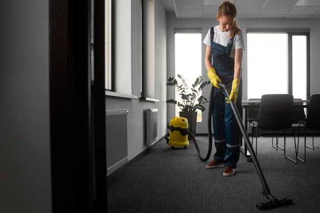 Full shot woman cleaning indoors