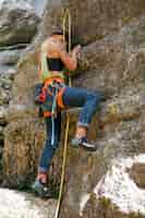 Free photo full shot woman climbing in the mountains