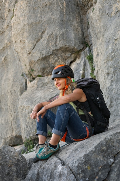 Free photo full shot woman climbing in the mountains