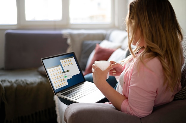 Full shot woman on couch working