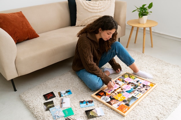 Free photo full shot woman creating inspiring vision board