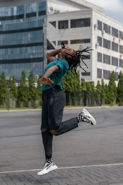 Full shot woman dancing on street