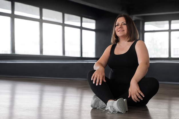 Full shot woman dancing in studio