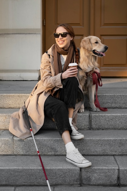 Free photo full shot woman and dog on stairs