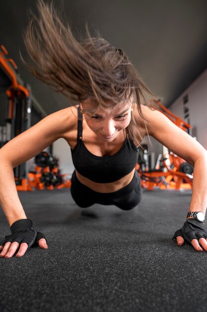 Full shot woman doing burpee