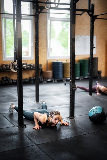 Full shot woman doing burpees