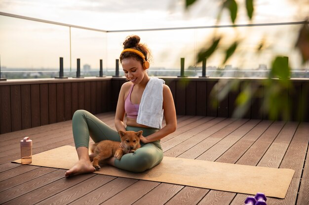 Full shot woman doing sport accompanied by dog