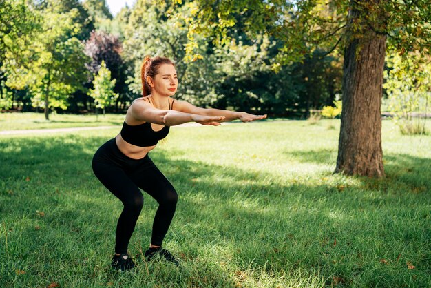 Full shot woman doing squats