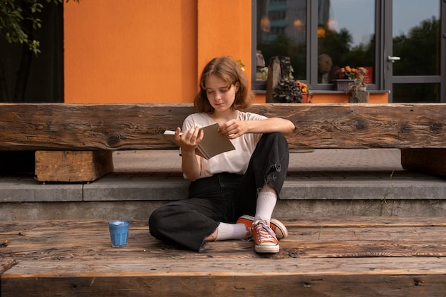 Full shot woman enjoying a blue matcha