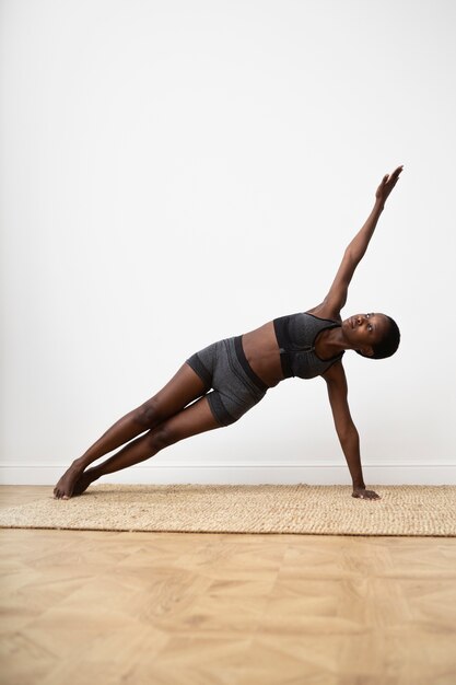 Full shot woman exercising at home