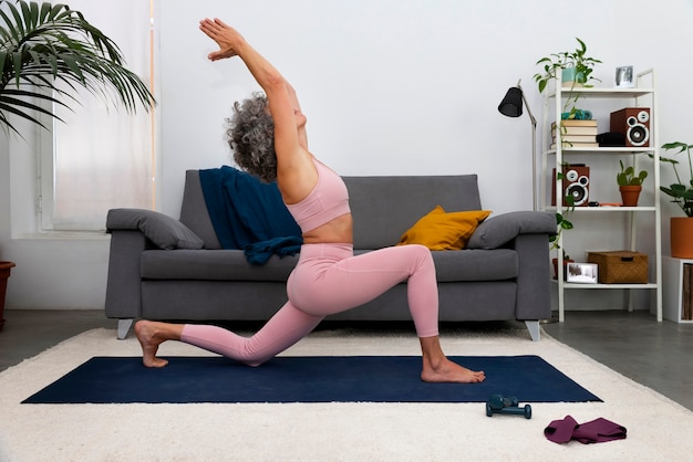 Full shot woman exercising indoors