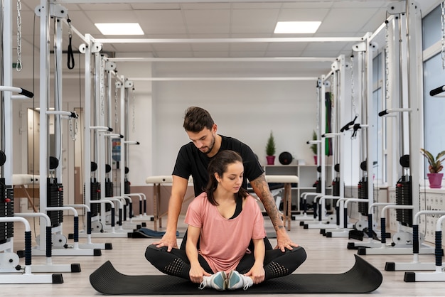 Full shot woman exercising on mat