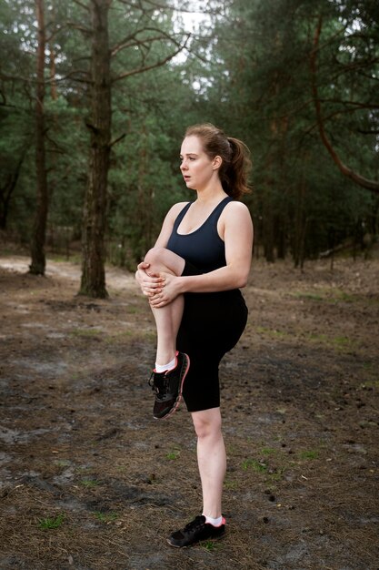 Full shot woman exercising outdoors