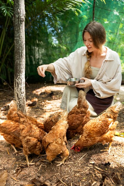 Full shot woman feeding the birds