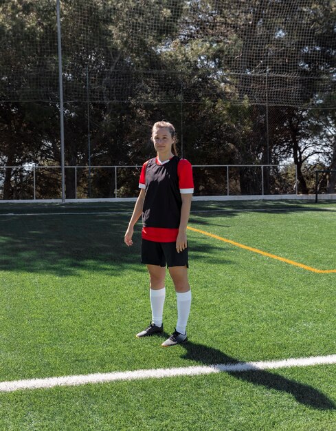 Full shot woman on football field