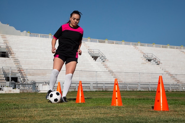 Full shot woman football player on field