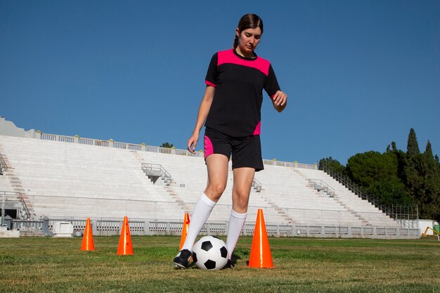 フィールド上のフルショットの女性サッカー選手