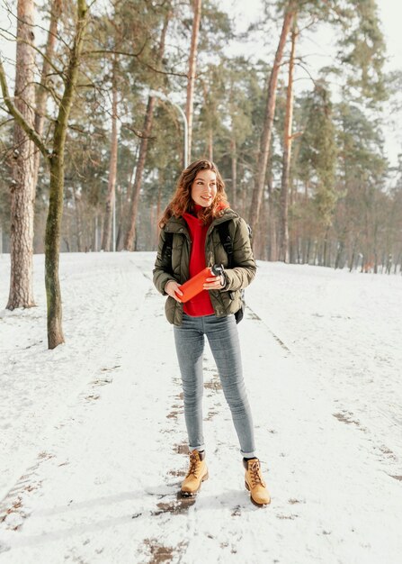 Full shot woman on forest road