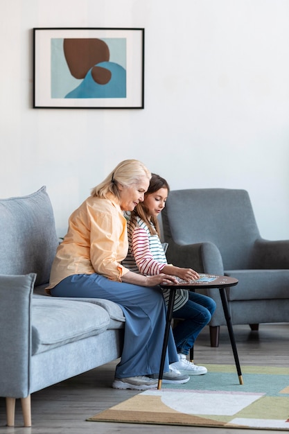 Full shot woman and girl in living room