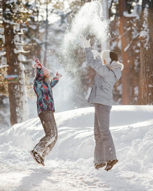 Full shot woman and girl playing together