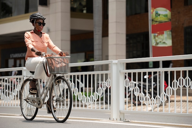 Full shot woman going to work on bicycle