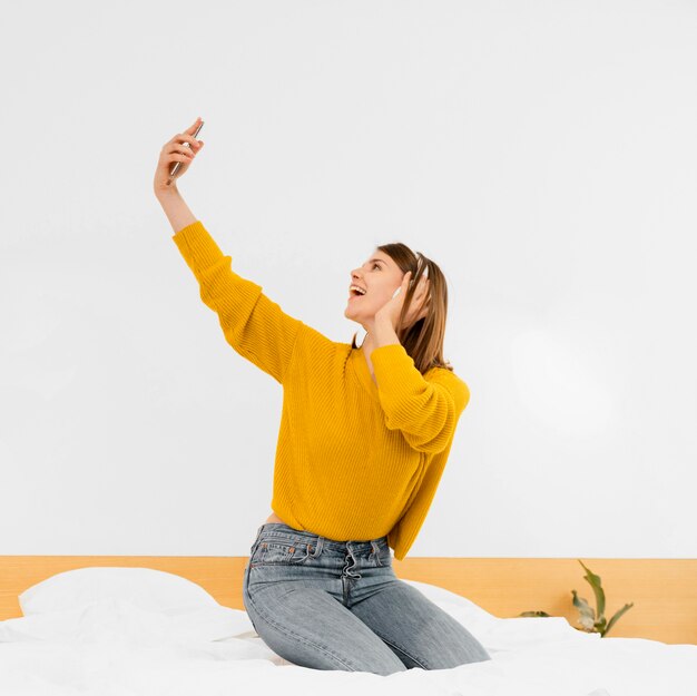 Full shot woman having fun indoors