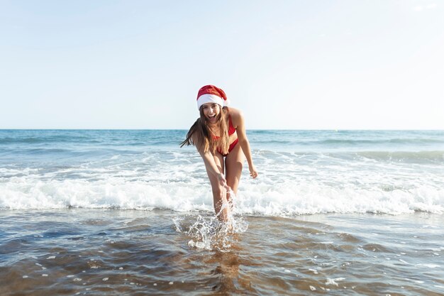 Full shot woman having fun at seaside