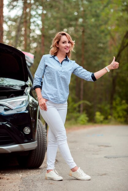 Full shot of woman hitchhiking