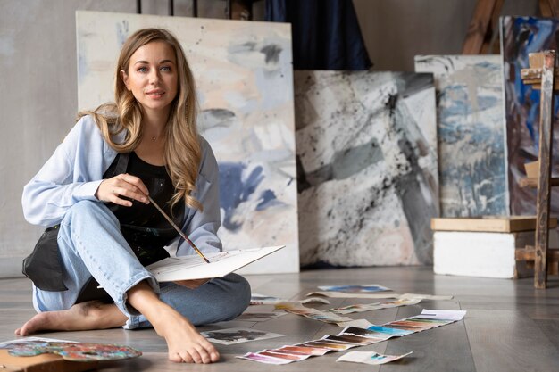 full shot woman holding brush
