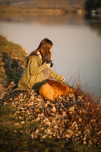 Full shot woman holding camera