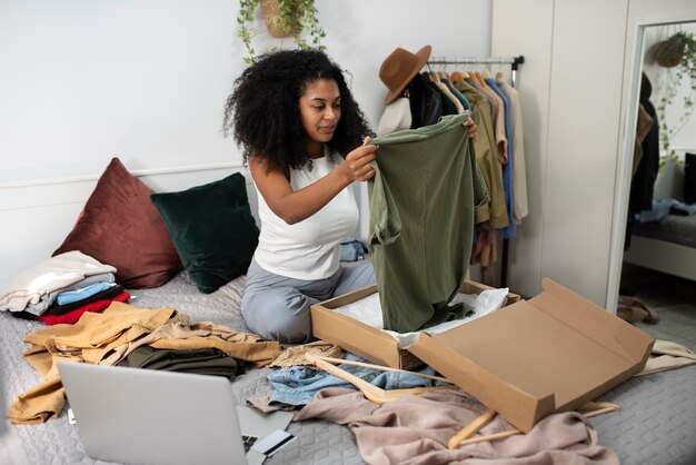 Full shot woman holding clothes