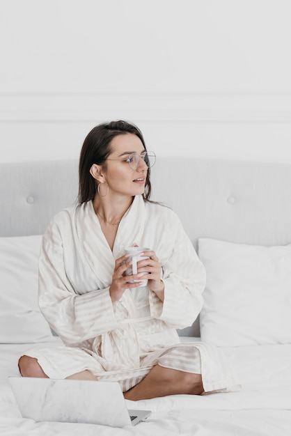 Full shot woman holding cup