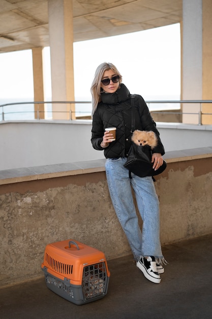 Full shot woman holding cute dog