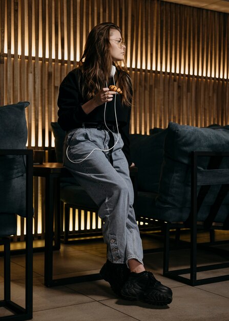 Full shot woman holding donut