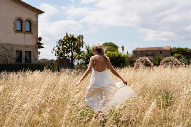 Full shot woman holding dress