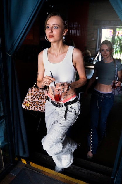 full shot woman holding drink