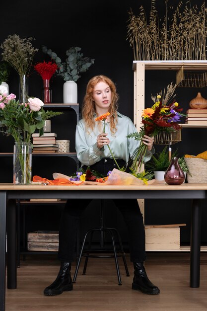 Full shot woman holding flowers