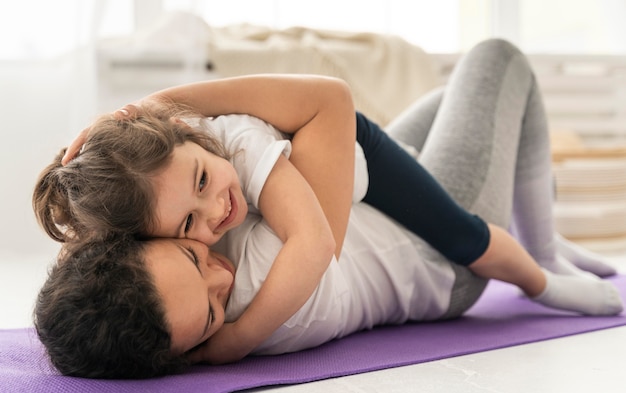 Free photo full shot woman holding girl