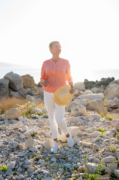 Full shot woman holding hat