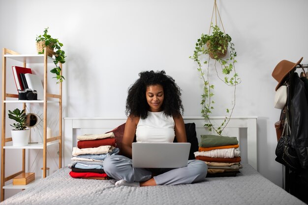 Full shot woman holding laptop